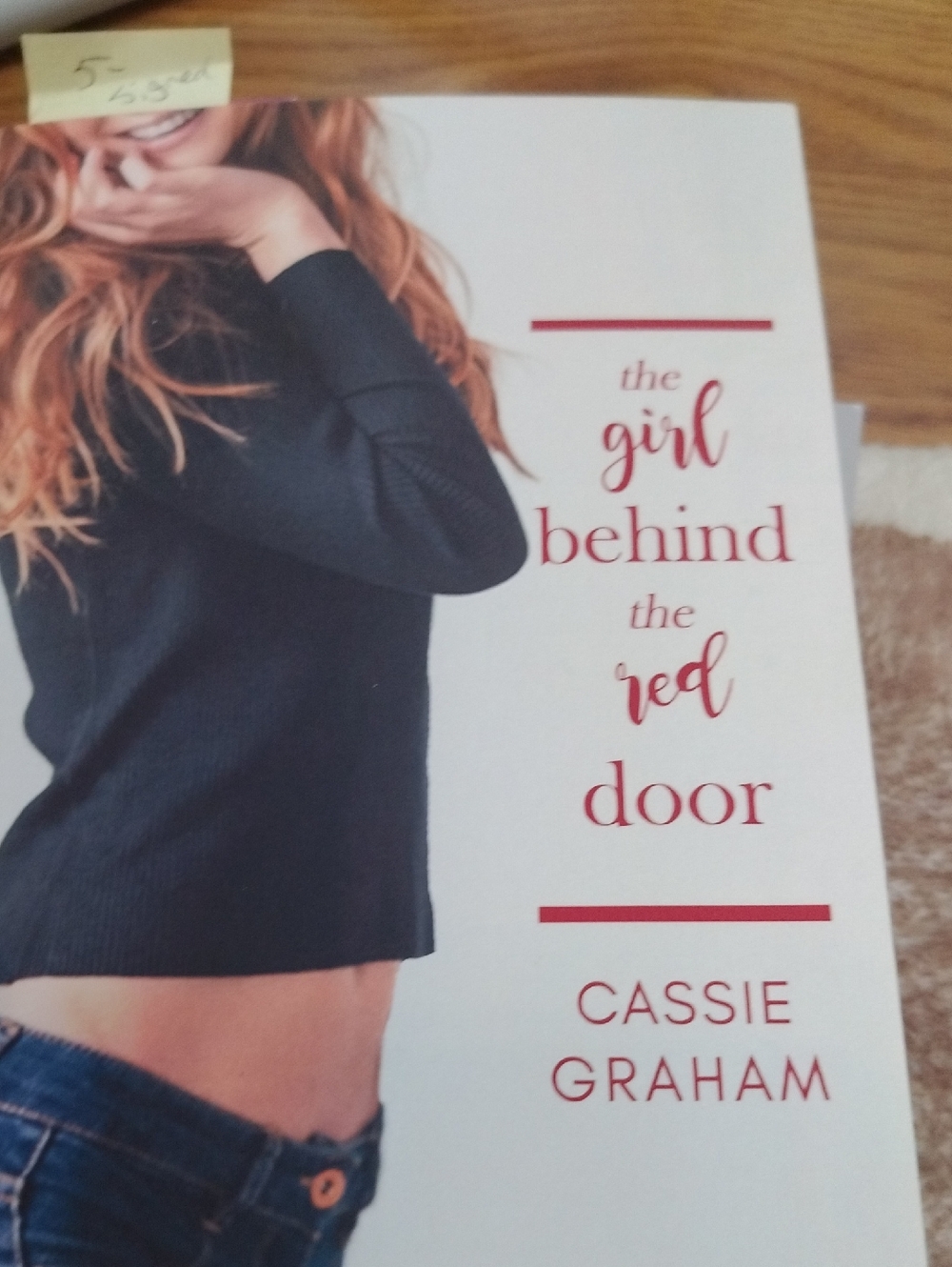 The Girl Behind the Red Door by Cassie Graham - Black Sweater Cover